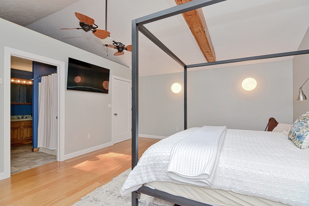 211 Beacon Street Framingham, MA 01701 - Photo 31 of 42 a bedroom with a large bed and a flat screen tv