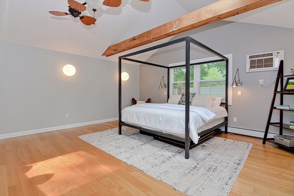 211 Beacon Street Framingham, MA 01701 - Photo 32 of 42 a bed sitting in a bedroom next to a window