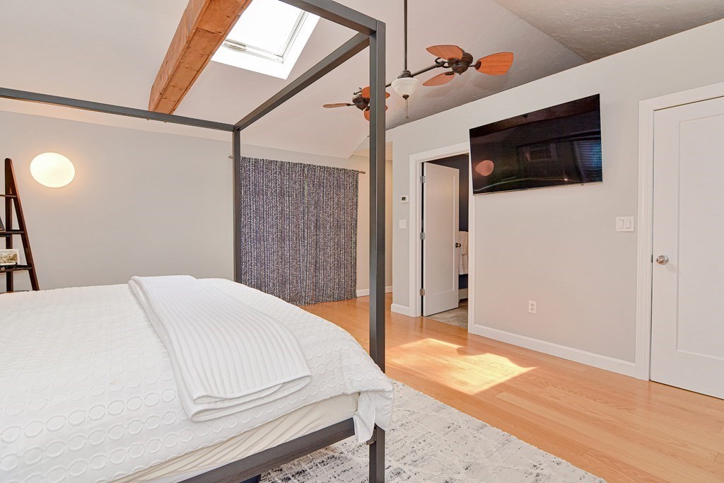 211 Beacon Street Framingham, MA 01701 - Photo 33 of 42 a bedroom with a bed and a flat screen tv