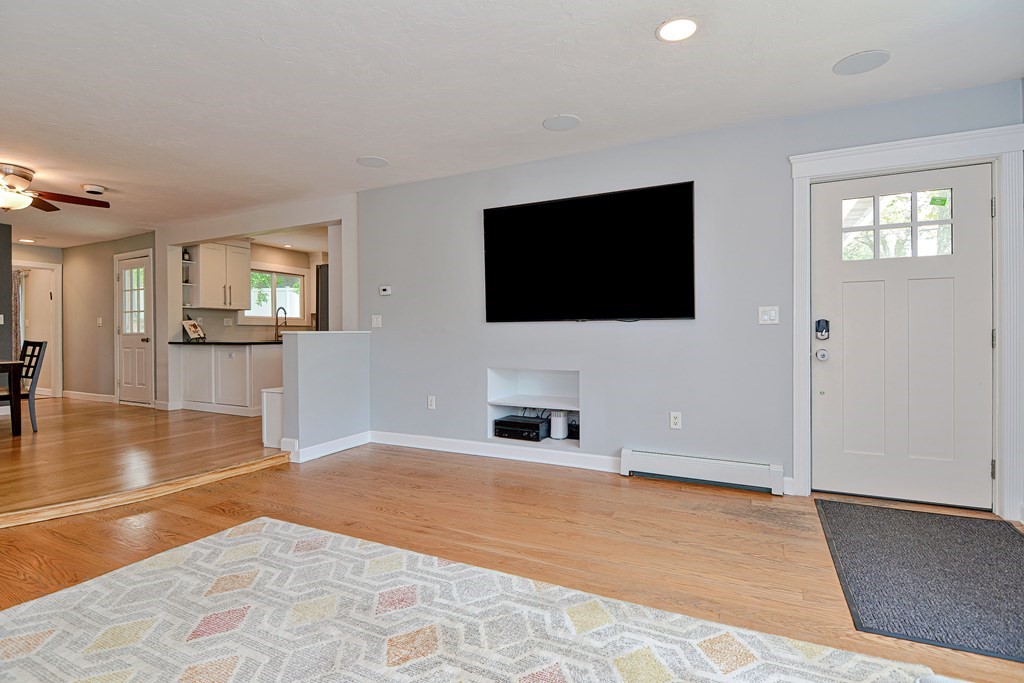 211 Beacon Street Framingham, MA 01701 - Photo 6 of 42 a view of a livingroom with wooden floor and a flat screen tv