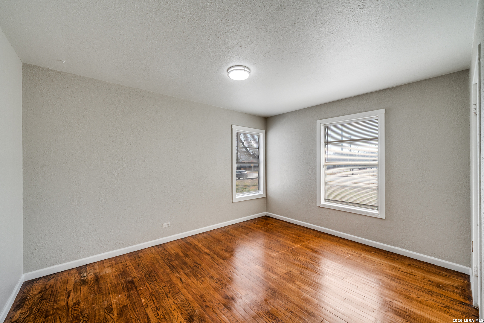 2307 Basse Road San Antonio, TX 78213 - Photo 9 of 17 an empty room with wooden floor and windows