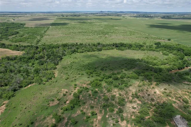 a view of a field with an ocean view