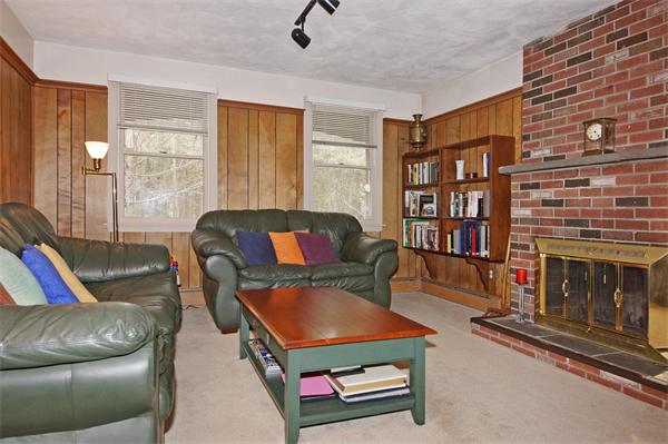 5 Woodside Road Framingham, MA 01701 - Photo 7 of 13 a living room with furniture a fireplace and a large window