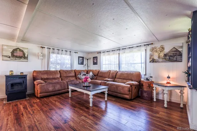 a living room with furniture and a book shelf
