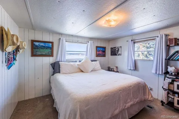 a bedroom with a bed dresser and a window
