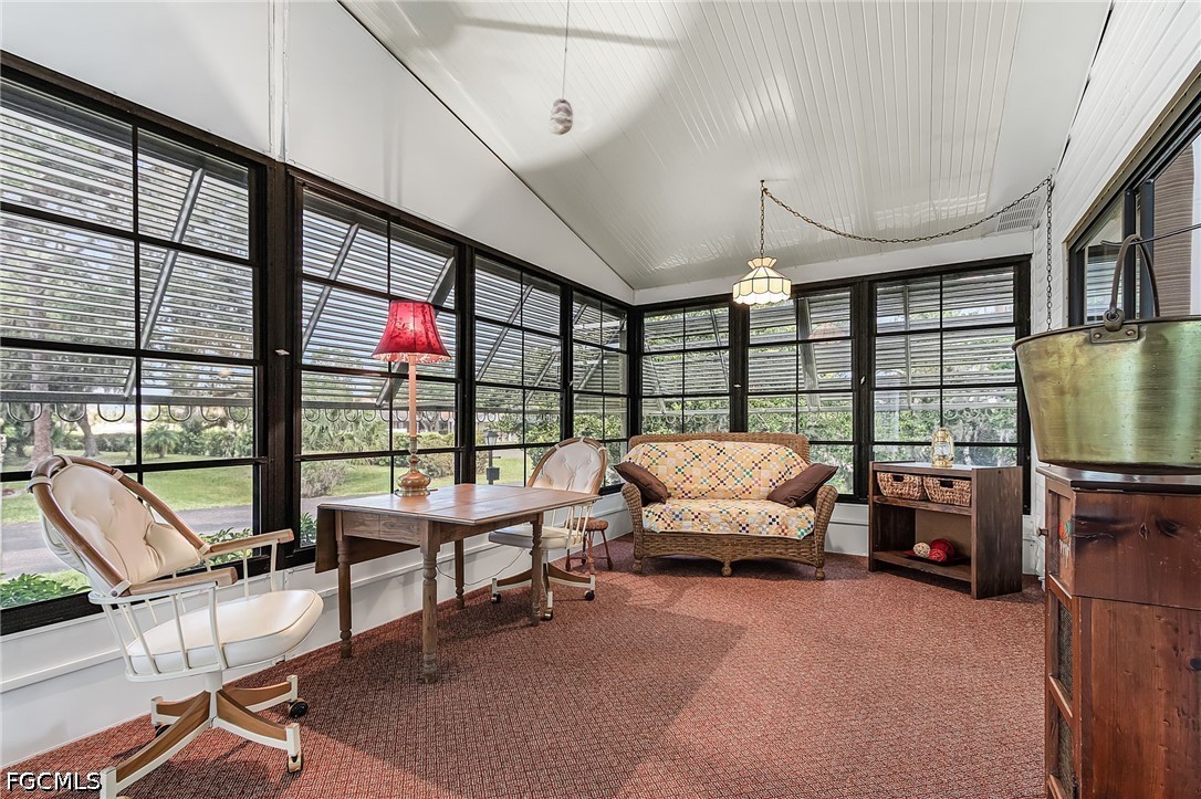 5 Erica Street Alva, FL 33920 - Photo 6 of 37 a living room with furniture a flat screen tv and floor to ceiling window
