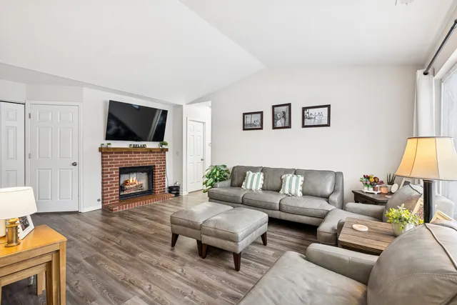 a view of a room with wooden floor table and chairs