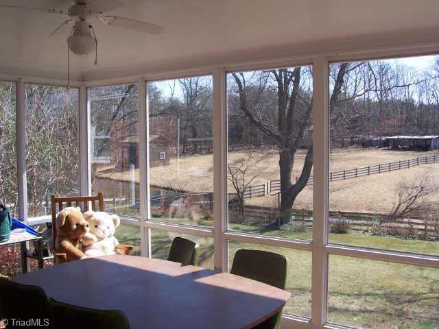 1116 Ritters Lake Road Greensboro, NC 27406 - Photo 2 of 6 Other. Relax in the sunroom while enjoying the peaceful view out back.