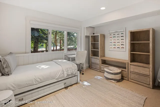 a bedroom with a bed and a large window