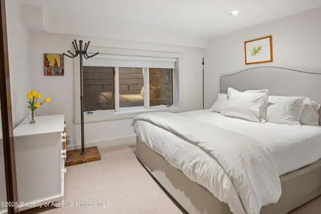 a bedroom with bed and window