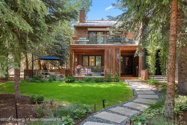 front view of a brick house with a yard