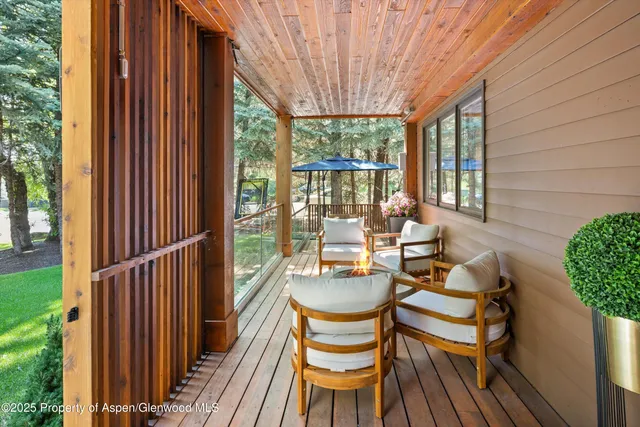 a balcony with chairs and outdoor view