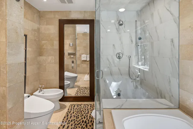 a bathroom with a granite countertop sink a mirror and a shower
