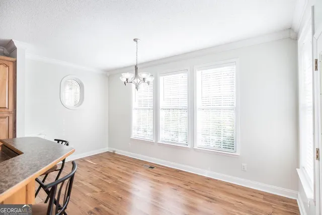 a view of a room with wooden floor and windows