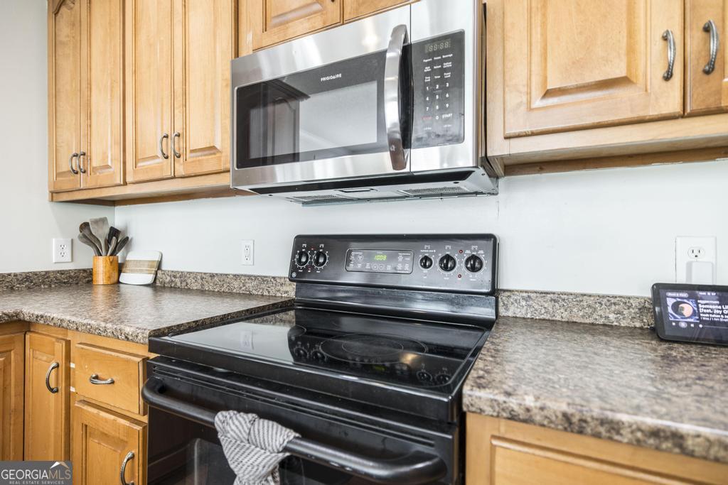119 William D Street Cochran, GA 31014 - Photo 15 of 42 a kitchen with stainless steel appliances granite countertop a stove and a microwave