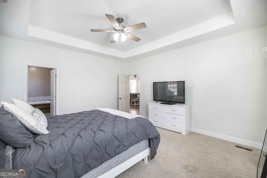 119 William D Street Cochran, GA 31014 - Photo 18 of 42 a bedroom with a bed and a flat screen tv