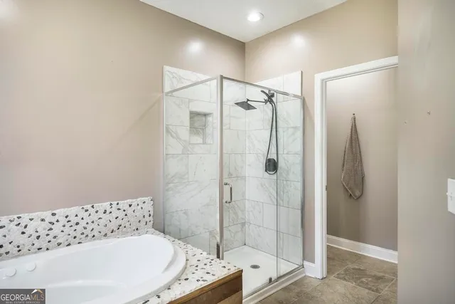 a bathroom with a bathtub and a shower