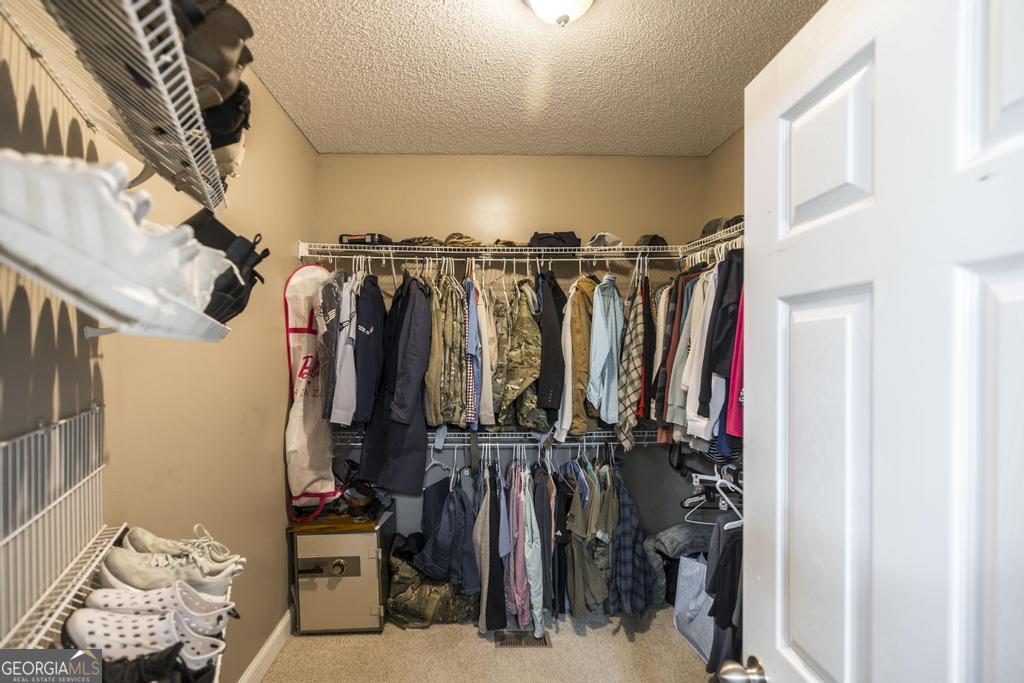119 William D Street Cochran, GA 31014 - Photo 21 of 42 a view of walk in closet with clothes and shoes