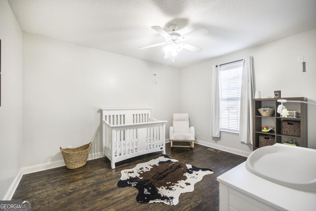 119 William D Street Cochran, GA 31014 - Photo 25 of 42 a living room with furniture and wooden floor