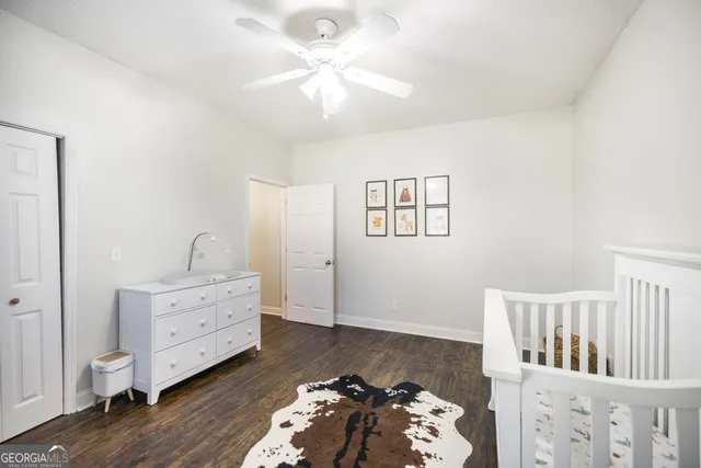 a bedroom with furniture and wooden floor