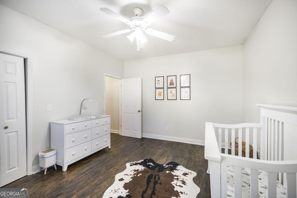 119 William D Street Cochran, GA 31014 - Photo 26 of 42 a bedroom with furniture and wooden floor