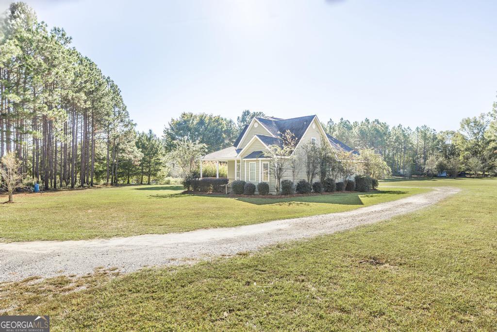 119 William D Street Cochran, GA 31014 - Photo 3 of 42 a view of an house with backyard and swimming pool