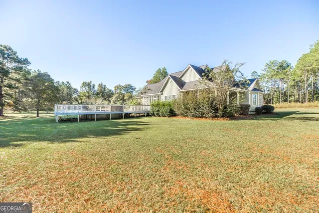 a view of house with garden space and trees