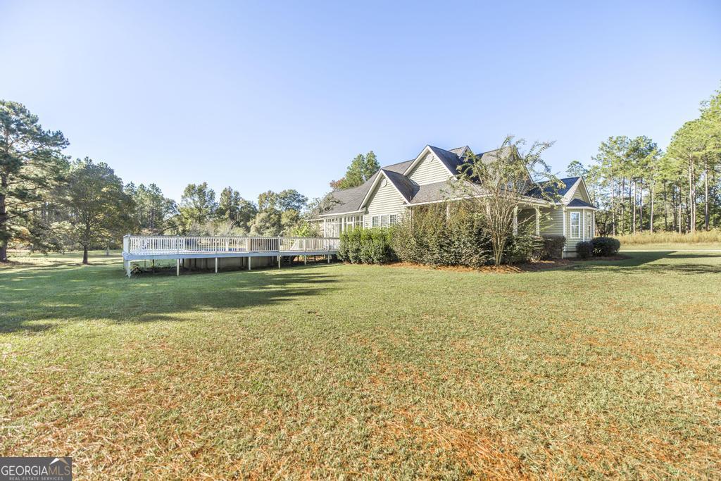 119 William D Street Cochran, GA 31014 - Photo 34 of 42 a view of house with garden space and trees