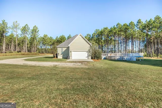 a house view with swimming pool in front of it