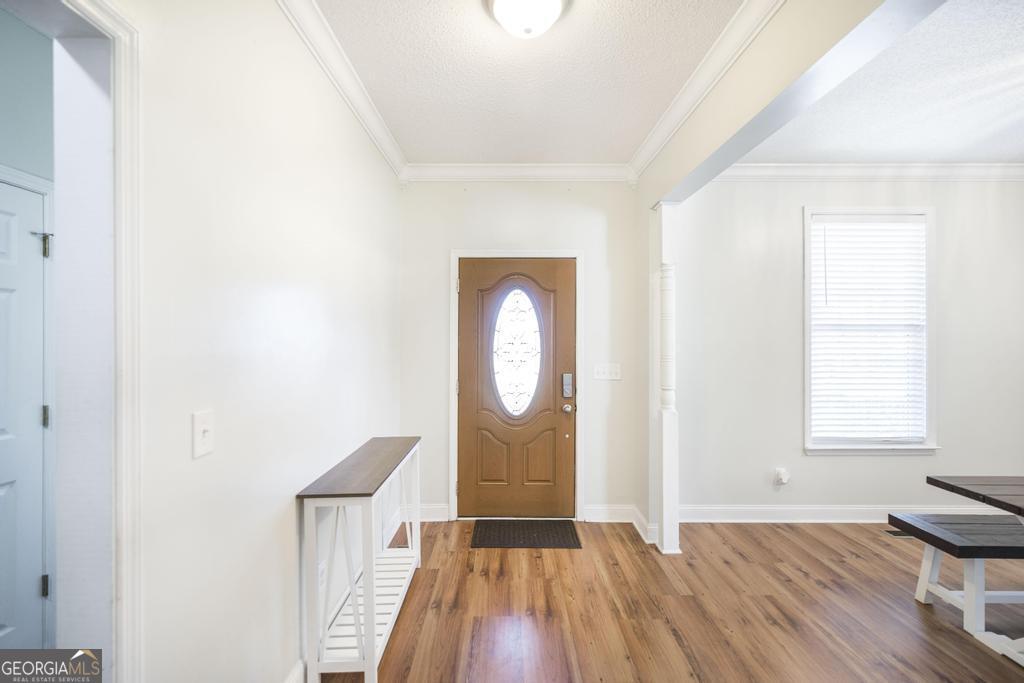 119 William D Street Cochran, GA 31014 - Photo 6 of 42 a view of empty room with wooden floor