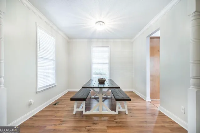 a floor to ceiling window and wooden floor