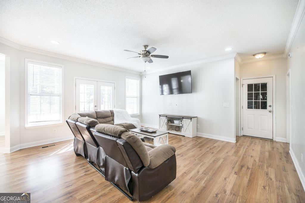 119 William D Street Cochran, GA 31014 - Photo 8 of 42 a living room with furniture and a wooden floor