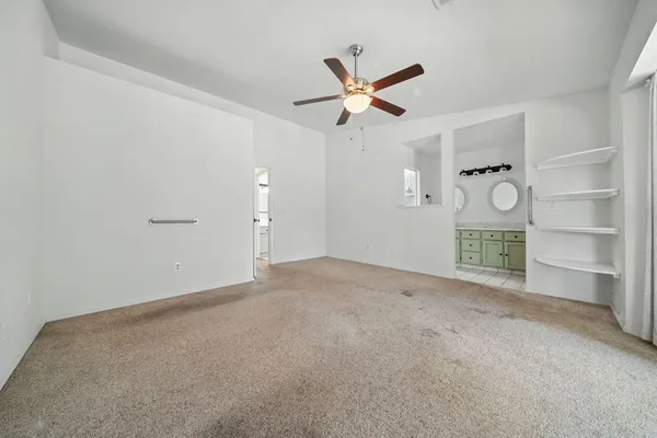 a view of an empty room and a bathroom