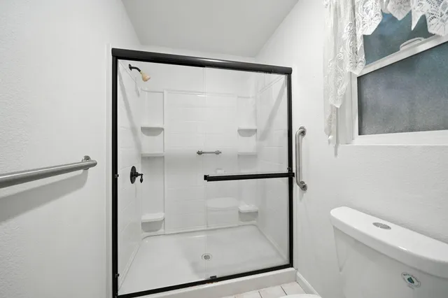 a bathroom with a glass shower door