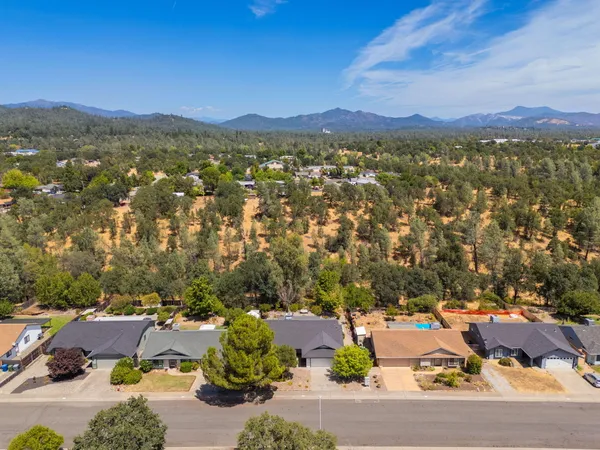 an aerial view of a house with a yard