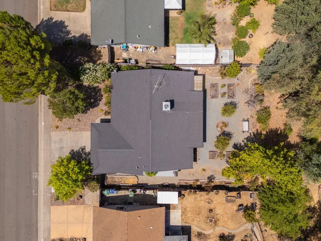 an aerial view of a house with a yard