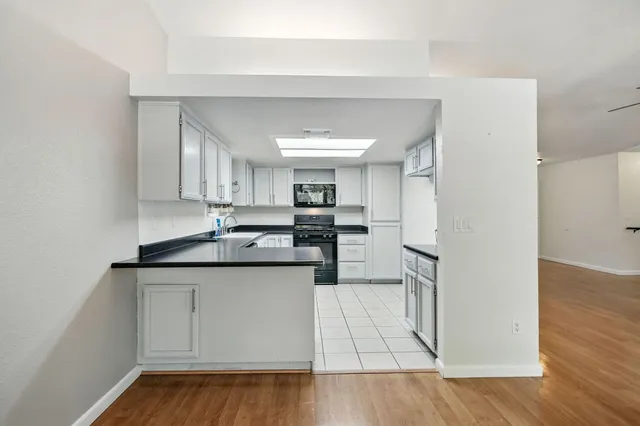 a kitchen with stainless steel appliances granite countertop a sink and cabinets