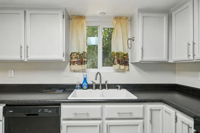 a kitchen with a sink and cabinets