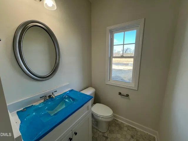 an empty room with windows and ceiling fan
