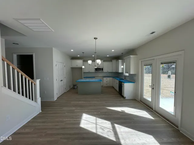 a large open kitchen with kitchen island granite countertop lots of counter top space