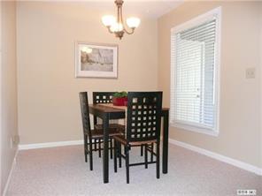 430 Queens Road, Unit 521 Charlotte, NC 28207 - Photo 2 of 7 a view of a dining room with furniture and chandelier