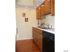 430 Queens Road, Unit 521 Charlotte, NC 28207 - Photo 3 of 7 a kitchen with a sink and a refrigerator