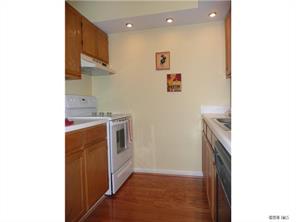 430 Queens Road, Unit 521 Charlotte, NC 28207 - Photo 4 of 7 a utility room with a sink a washer and dryer