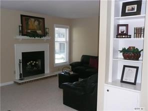 430 Queens Road, Unit 521 Charlotte, NC 28207 - Photo 5 of 7 a living room with furniture a flat screen tv and a fireplace