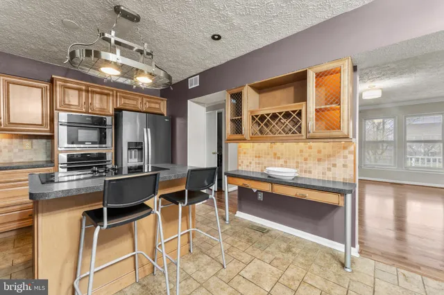 a kitchen with granite countertop cabinets and stainless steel appliances