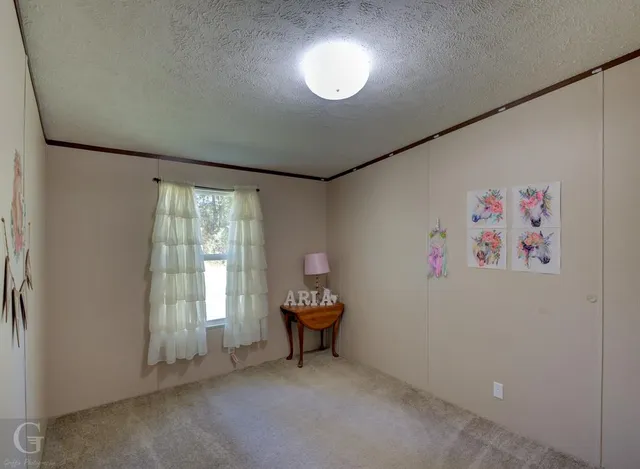 a view of workspace with fan and window