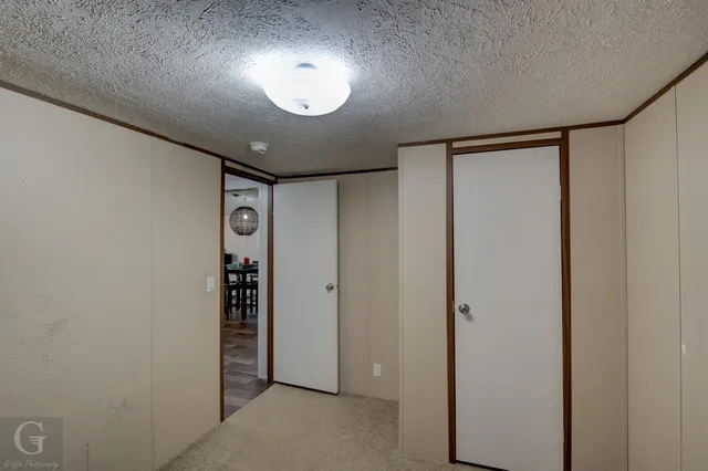 an empty room with entrance and windows