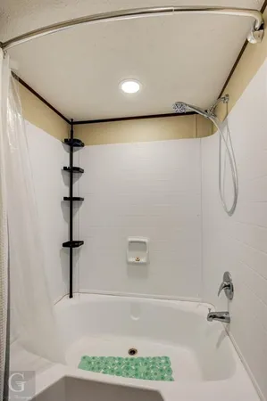 a bathroom with a bathtub and a shower