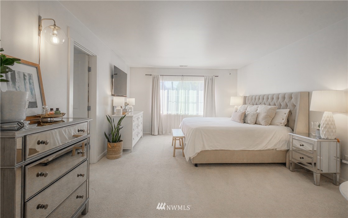 21807 38th Drive Southeast Bothell, WA 98021 - Photo 15 of 30 a spacious bedroom with a bed and a dresser