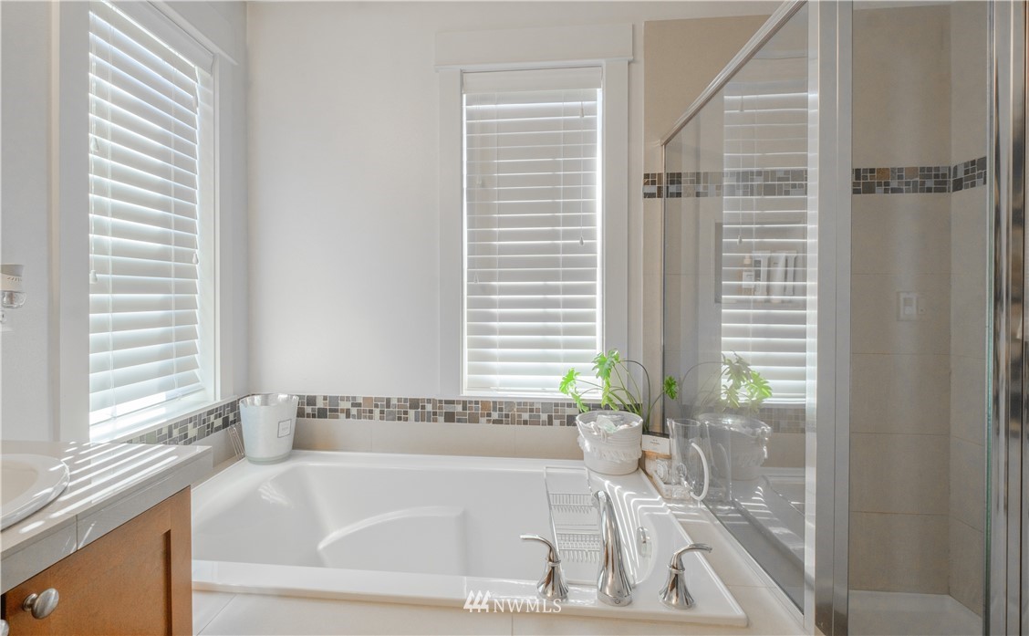 21807 38th Drive Southeast Bothell, WA 98021 - Photo 18 of 30 a bath tub sitting in a bathroom next to a window